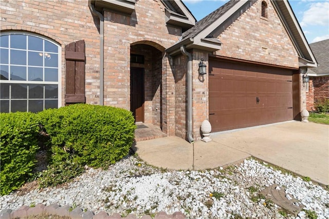 exterior space with a garage and brick siding
