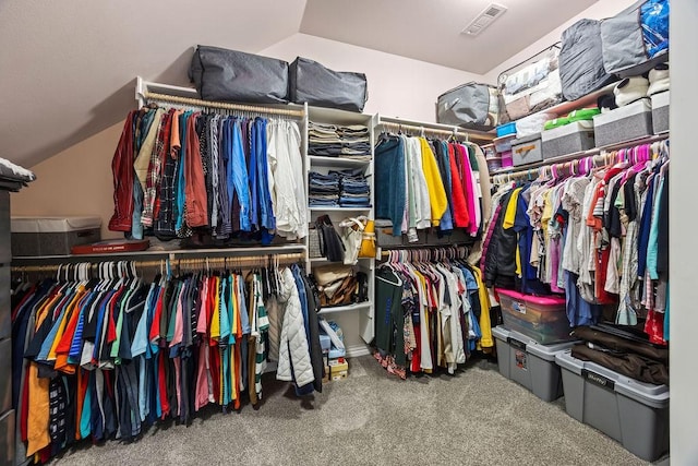 spacious closet with visible vents, carpet, and lofted ceiling