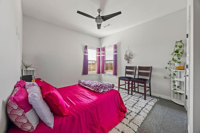 carpeted bedroom with visible vents, ceiling fan, and baseboards