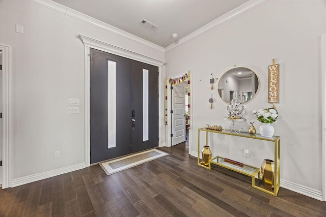 foyer entrance featuring crown molding, wood finished floors, visible vents, and baseboards