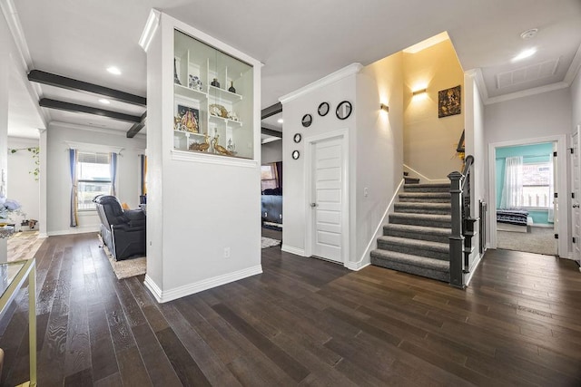 interior space with a healthy amount of sunlight, baseboards, ornamental molding, and wood finished floors