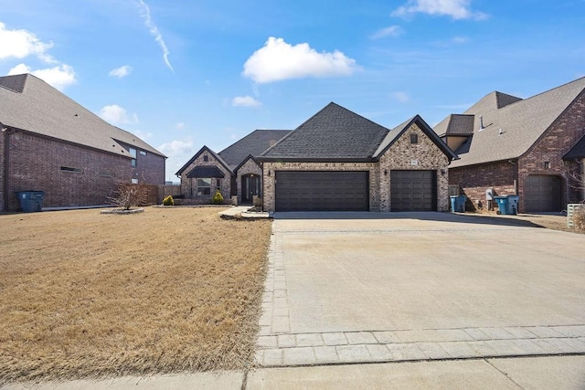 french provincial home with driveway, a shingled roof, a front lawn, a garage, and brick siding