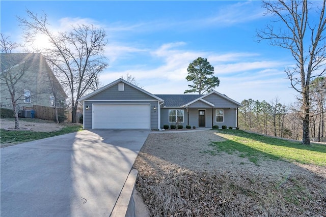 ranch-style house with concrete driveway, an attached garage, fence, and a front lawn