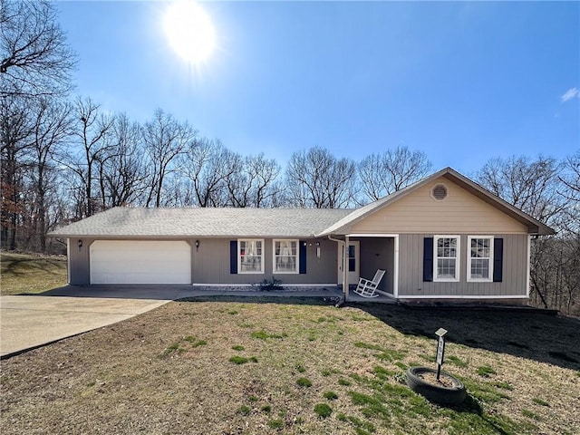 ranch-style home with driveway, a front lawn, a porch, and an attached garage