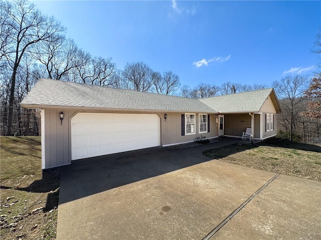 single story home featuring a garage, driveway, and roof with shingles