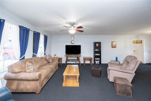 carpeted living room with baseboards and ceiling fan