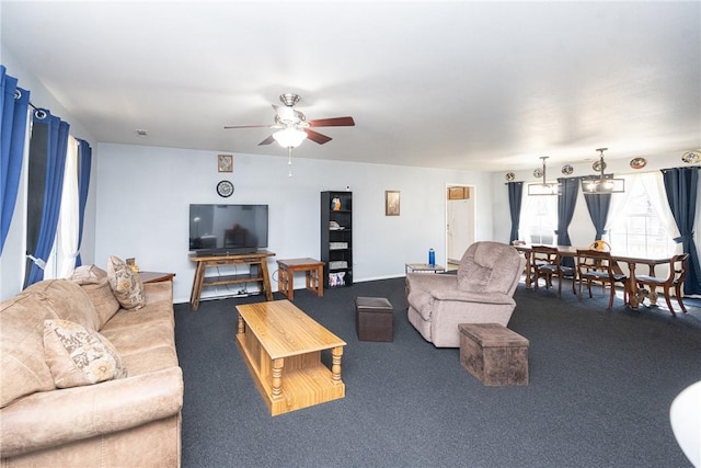 carpeted living area with ceiling fan