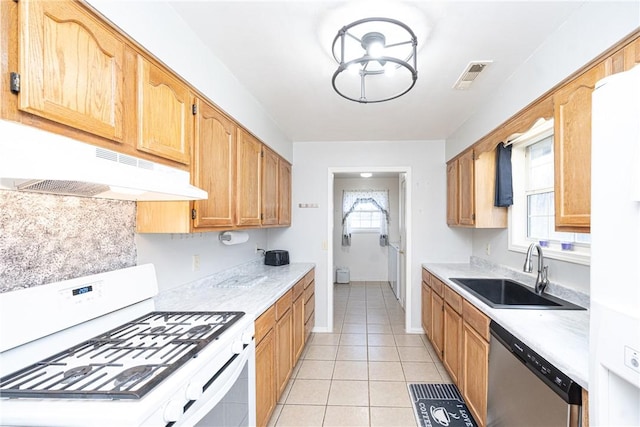 kitchen featuring white range with gas cooktop, a sink, under cabinet range hood, light countertops, and dishwasher