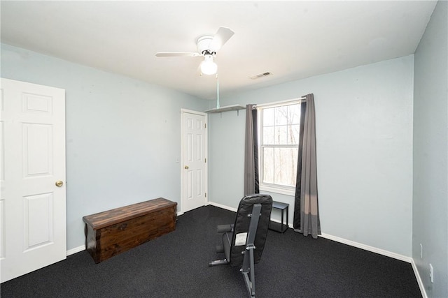 exercise area featuring visible vents, baseboards, and a ceiling fan