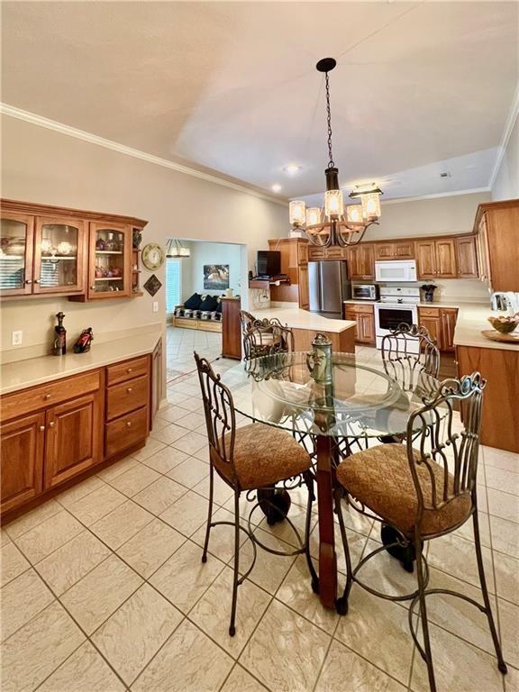 11 Saint Andrews Lane Holiday Island Unit 9, Holiday Island, AR 72631 - dining space featuring crown molding, light tile patterned floors, and a chandelier
