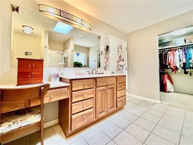 11 Saint Andrews Lane Holiday Island Unit 9, Holiday Island, AR 72631 - full bathroom featuring vanity, a skylight, tile patterned flooring, a shower stall, and a walk in closet