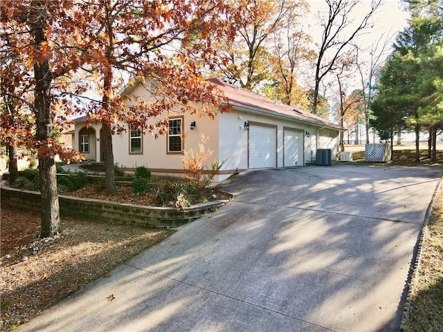 11 Saint Andrews Lane Holiday Island Unit 9, Holiday Island, AR 72631 - view of side of home with driveway, stucco siding, and an attached garage