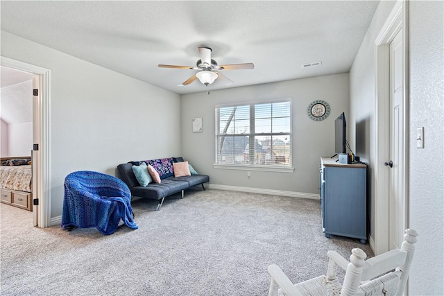 sitting room featuring ceiling fan, carpet, visible vents, and baseboards