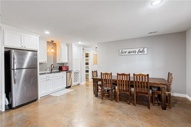 dining area with baseboards, visible vents, recessed lighting, concrete flooring, and a textured ceiling