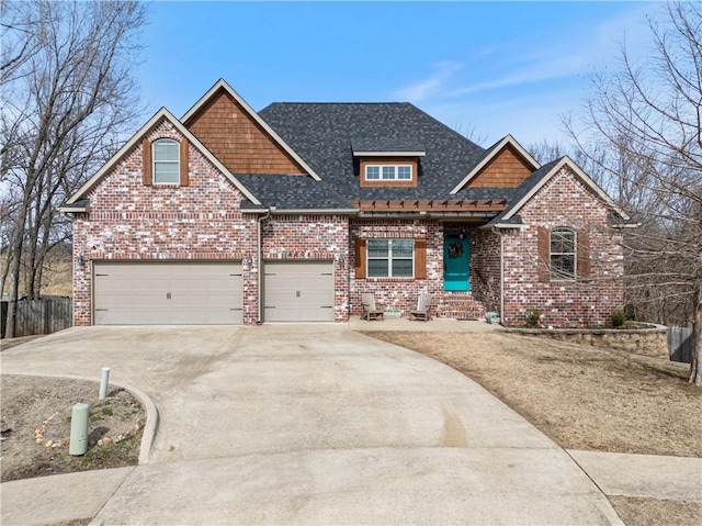 craftsman inspired home with driveway, fence, roof with shingles, an attached garage, and brick siding