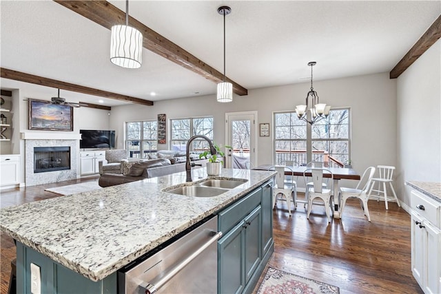 kitchen featuring dark wood-style floors, beam ceiling, a fireplace, a sink, and dishwasher