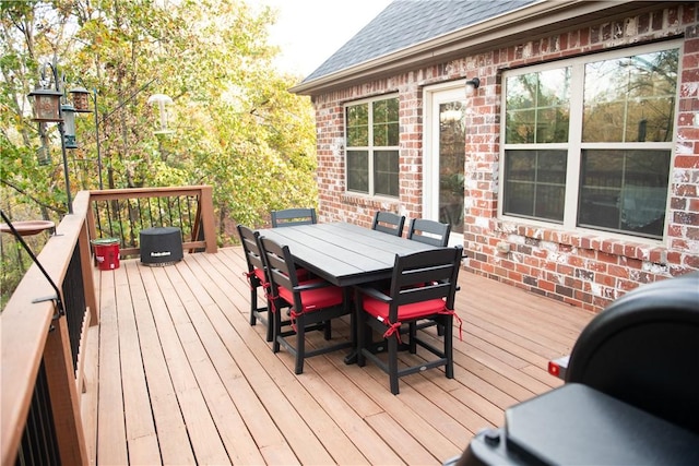 wooden deck featuring outdoor dining area