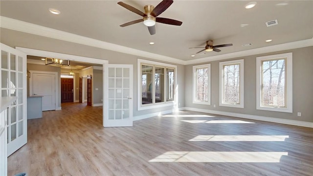 spare room with ornamental molding, recessed lighting, french doors, light wood-style floors, and baseboards