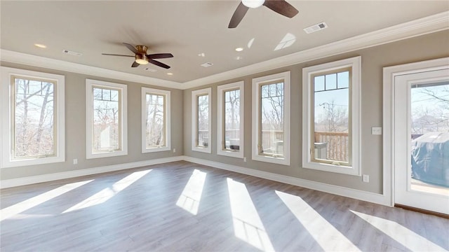 unfurnished sunroom with visible vents and ceiling fan