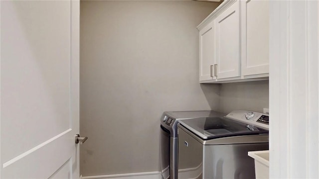 laundry area with cabinet space, washing machine and dryer, and a sink