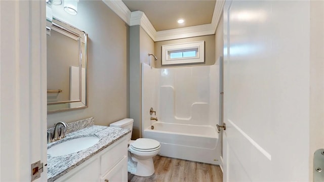 bathroom featuring vanity, wood finished floors, ornamental molding, shower / bathing tub combination, and toilet