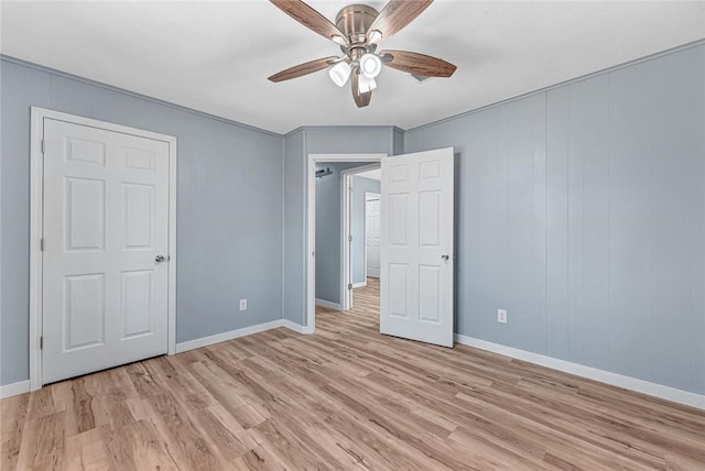 unfurnished bedroom with light wood finished floors, ceiling fan, and baseboards