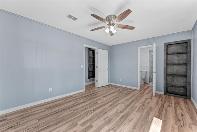 unfurnished bedroom featuring visible vents, light wood-style flooring, ensuite bath, baseboards, and ceiling fan