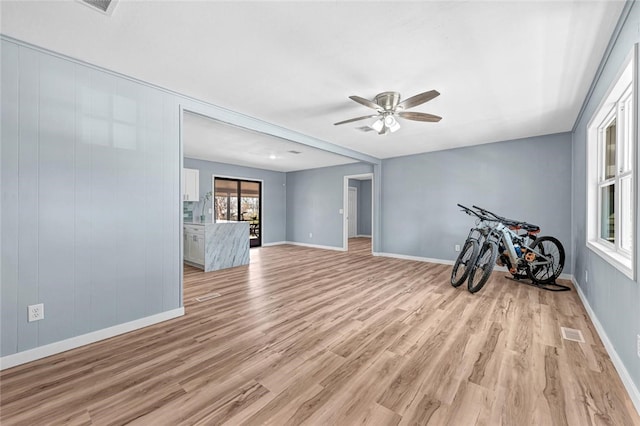 spare room with visible vents, baseboards, light wood-style floors, and a ceiling fan