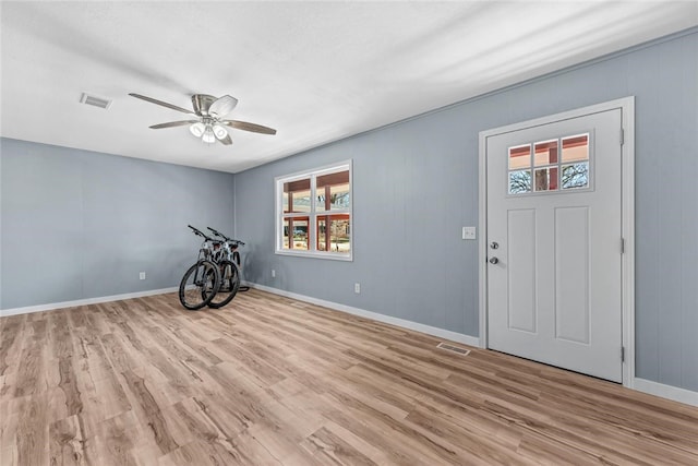 entryway with baseboards, wood finished floors, visible vents, and ceiling fan