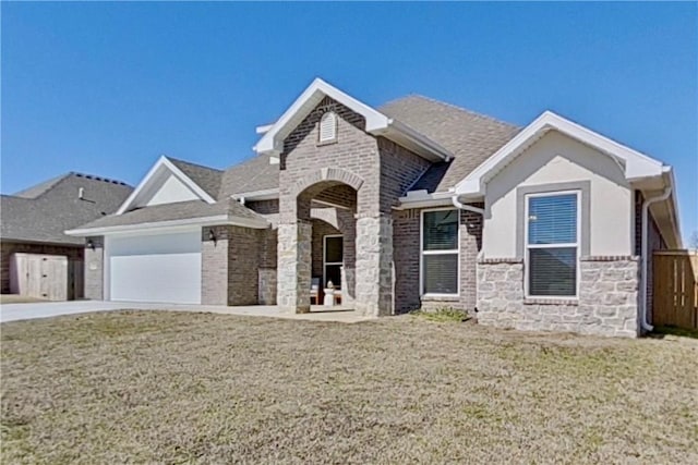 view of front of home featuring brick siding, a front lawn, concrete driveway, a garage, and stone siding