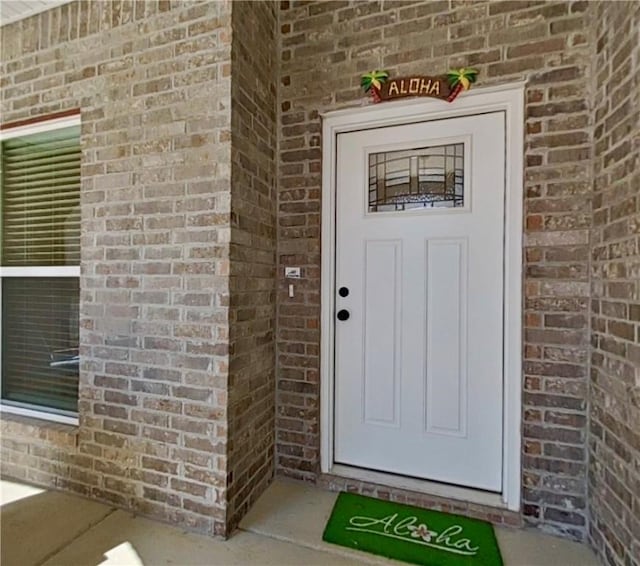 property entrance with brick siding