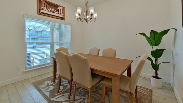 dining space with a chandelier and baseboards