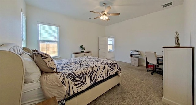 bedroom featuring visible vents, multiple windows, a ceiling fan, and carpet floors