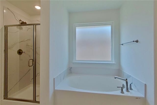 bathroom with a marble finish shower and a bath