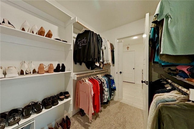 walk in closet with carpet