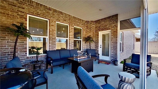 view of patio with an outdoor living space with a fire pit