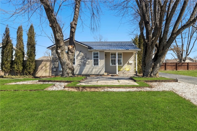 706 NW B St, Bentonville, AR 72712 - view of front of house featuring fence, a front yard, and metal roof