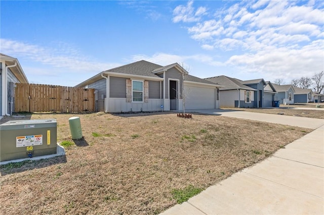 single story home featuring a residential view, concrete driveway, an attached garage, and fence