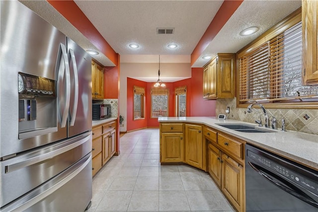 kitchen with visible vents, light countertops, light tile patterned flooring, black appliances, and a sink