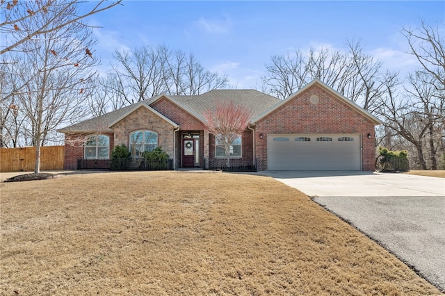 single story home with brick siding, fence, a front yard, a garage, and driveway