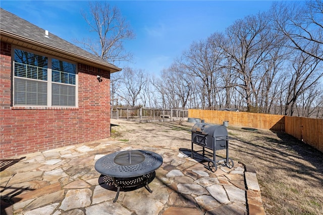 view of patio featuring a grill, an outdoor fire pit, and a fenced backyard