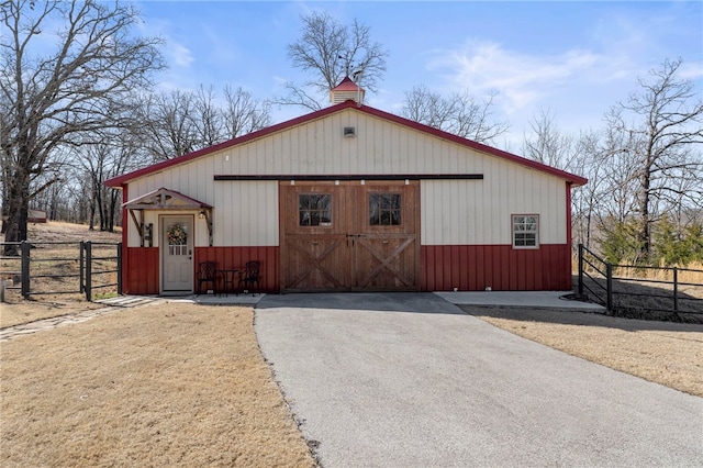 exterior space featuring an outdoor structure and fence