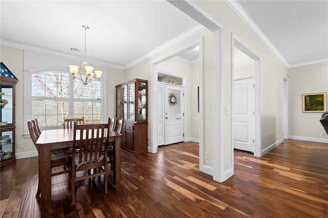 dining room featuring visible vents, crown molding, dark wood-type flooring, and an inviting chandelier