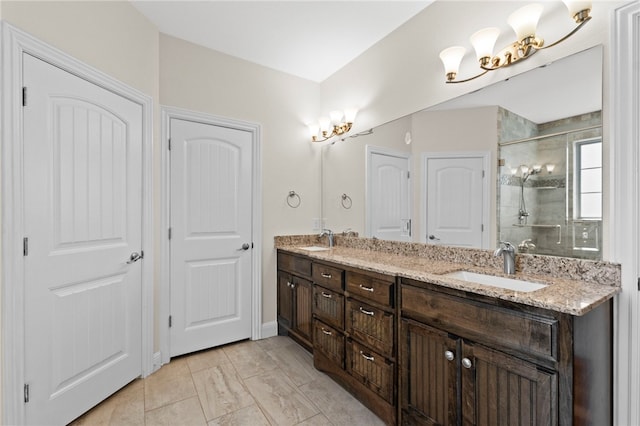 bathroom featuring a shower stall, double vanity, and a sink