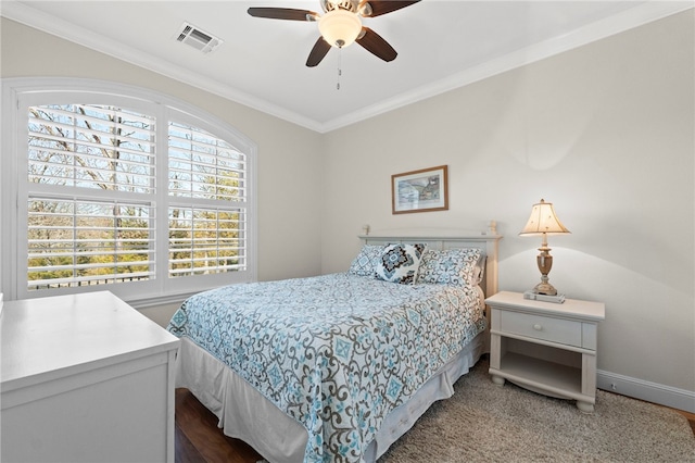 bedroom featuring a ceiling fan, baseboards, visible vents, ornamental molding, and dark carpet