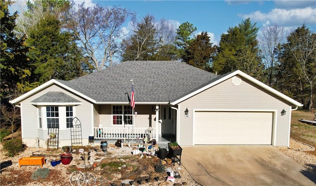 ranch-style home featuring a porch, an attached garage, concrete driveway, and a shingled roof