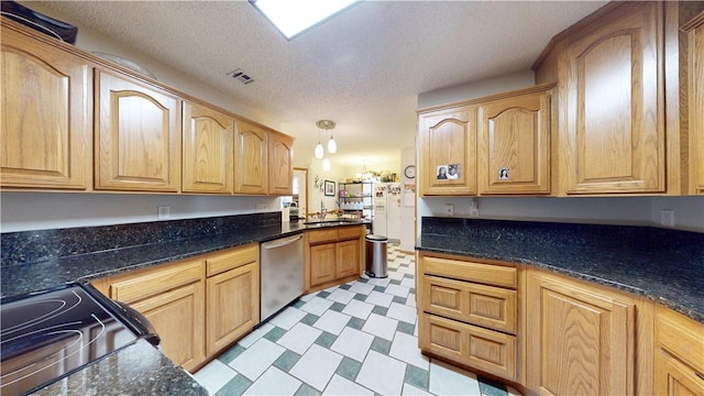 kitchen featuring visible vents, light floors, dishwasher, black electric range, and a sink