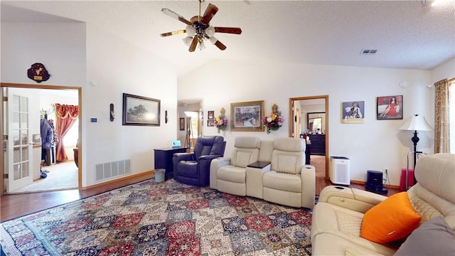 living area featuring vaulted ceiling, wood finished floors, visible vents, and ceiling fan