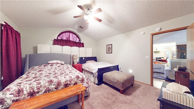 carpeted bedroom featuring lofted ceiling, a ceiling fan, visible vents, and a textured ceiling