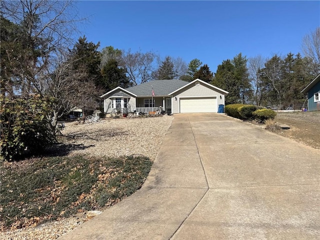 single story home featuring covered porch, concrete driveway, and an attached garage